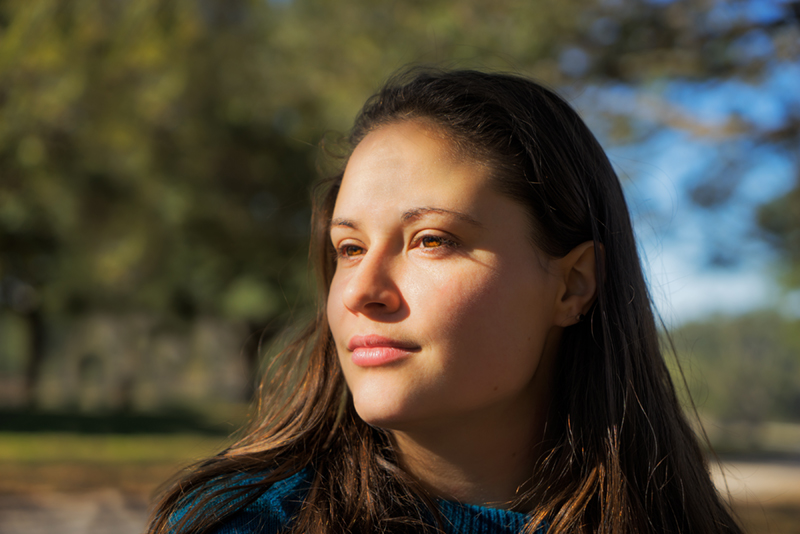 woman looking off to side in contemplation.